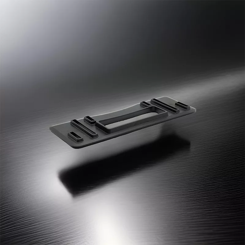 Black molded rubber part on silver background